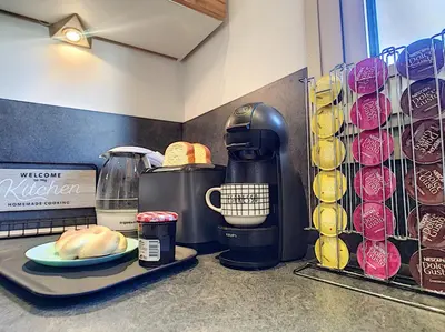 a coffee maker on a counter with a plate of bread at Nestor&Jeeves - SUNSET TERRACE - Central - Free parking - Top floor in Nice