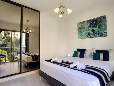a bedroom with a large bed with towels on it at Nestor&Jeeves - SUNSET TERRACE - Central - Free parking - Top floor in Nice