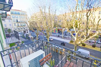 a view of a city street from a balcony at PROMENADE HOLIDAY - GRIMALDI CITY CENTER in Nice