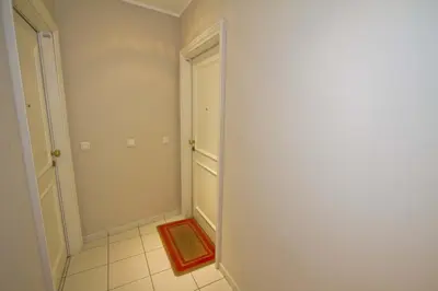 a hallway with a door and a red rug at PROMENADE HOLIDAY - GRIMALDI CITY CENTER in Nice