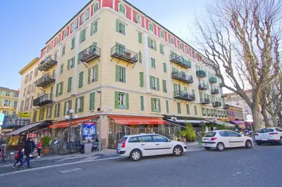 a large building with cars parked in front of it at PROMENADE HOLIDAY - GRIMALDI CITY CENTER in Nice