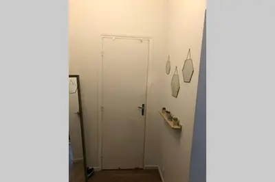 a bathroom with a white door in a room at Appartement NICE proche MER et CENTRE in Nice