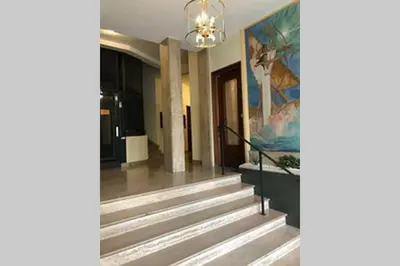 a staircase in a building with a painting on the wall at Appartement NICE proche MER et CENTRE in Nice