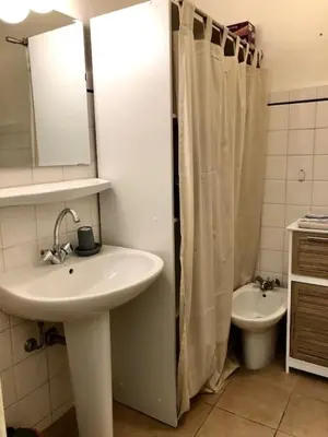 a bathroom with a sink and a toilet and a mirror at Appartement NICE proche MER et CENTRE in Nice
