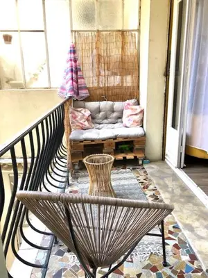 a balcony with a bench and a couch on a porch at Appartement NICE proche MER et CENTRE in Nice