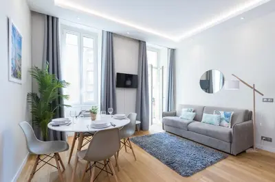a living room with a table and a couch at Brand New 1 Bdr Place du Pin in Nice