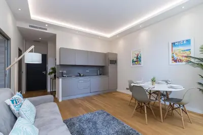 a living room with a couch and a table at Brand New 1 Bdr Place du Pin in Nice