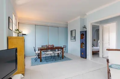a living room with a table and a tv at Extraordinary View on Port and Castle Hill - 1 Bdr & Parking in Nice