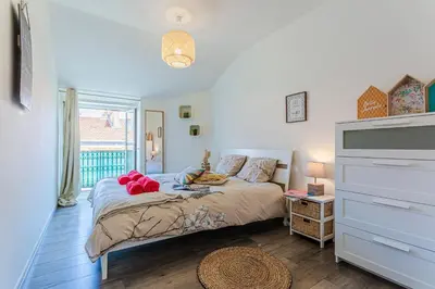 a bedroom with a bed and a large window at Maison Bianchi - Saint Siagre in Nice