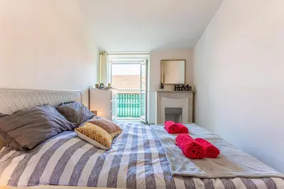 a bedroom with a bed with red roses on it at Maison Bianchi - Saint Siagre in Nice