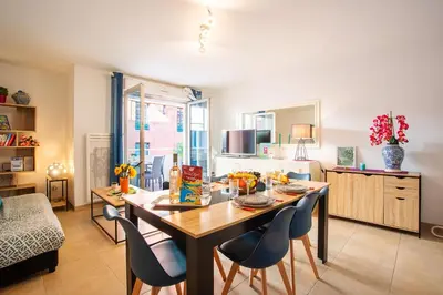 a kitchen with a table and chairs in a room at PALAIS OTHELLO in Nice
