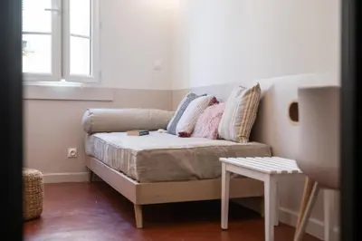a couch with pillows on it in a room at Papa Riviera - Nice old town - 1-3 pers in Nice