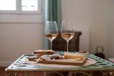 a table with two glasses of wine and bread at Papa Riviera - Nice old town - 1-3 pers in Nice