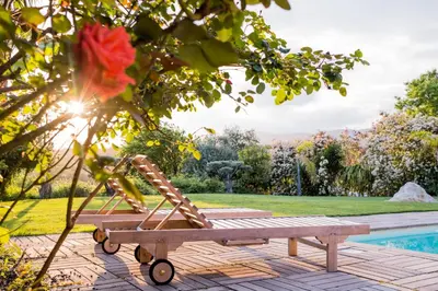 a wooden bench sitting next to a pool at Villa Angel in La Gaude