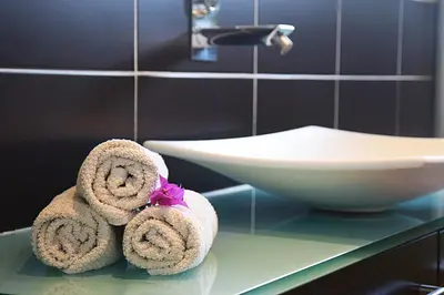 a bathroom with towels on a counter next to a sink at Villa Angel in La Gaude