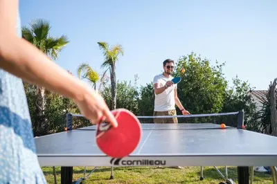 a man playing ping pong on a ping pong table at Villa Angel in La Gaude