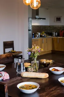 a kitchen with a wooden table with bowls of food at Villa Angel in La Gaude