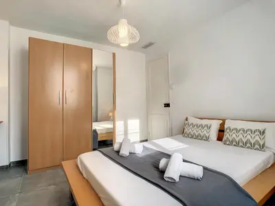 a bedroom with a large bed and a closet at Nestor&Jeeves - BOW WINDOW BUFFA - City center - Very close beach in Nice