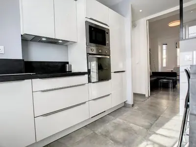 a kitchen with white cabinets and a microwave at Nestor&Jeeves - BOW WINDOW BUFFA - City center - Very close beach in Nice