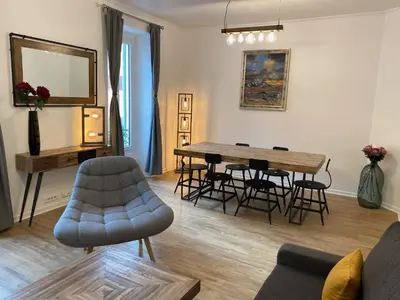 a living room with a table and chairs and a mirror at Chic and Cosy apartment GV Port Garibaldi in Nice