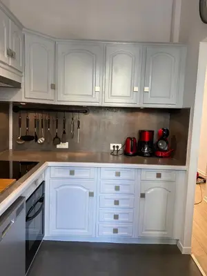 a white kitchen with white cabinets and appliances at Chic and Cosy apartment GV Port Garibaldi in Nice
