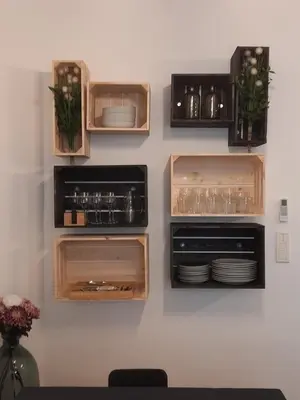 a wall with wooden drawers with plates and glasses at Chic and Cosy apartment GV Port Garibaldi in Nice