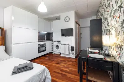 a bedroom with a bed and a desk in a room at Studio en plein cœur de la vieille ville à Nice in Nice