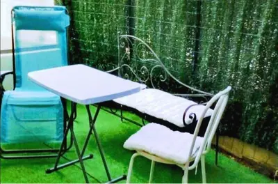 a table and two chairs and a table and a chair at NICE VIEW Jolie Studio avec Jardin in Nice