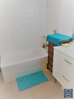 a bathroom with a white tub and a blue rug at NICE VIEW Jolie Studio avec Jardin in Nice