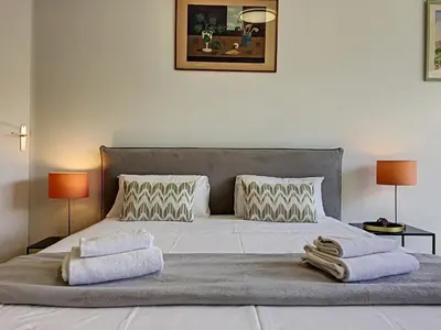 a bedroom with a large bed with towels on it at Nestor&Jeeves - BERLIOZ SUITE - Downtown - Close beaches in Nice
