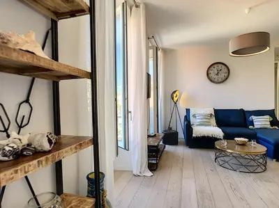 a living room with a blue couch and a table at Nestor&Jeeves - MASSENA DREAM - Hyper center - Close sea in Nice