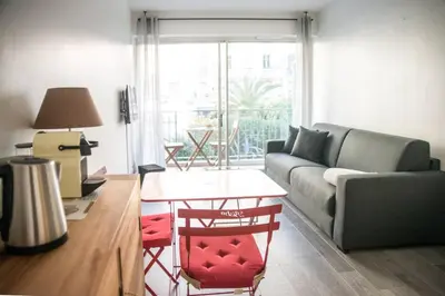 a living room with a couch and a table at STUDIO ORANGERS in Nice