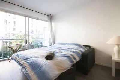 a bedroom with a bed with a teddy bear on it at STUDIO ORANGERS in Nice