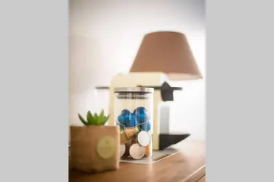 a table with a lamp and a glass jar on it at STUDIO ORANGERS in Nice