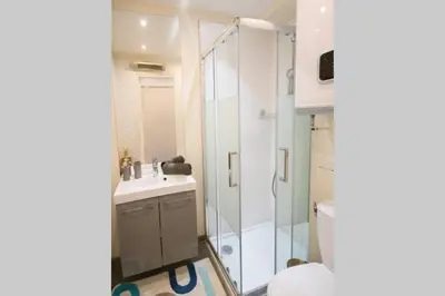 a bathroom with a shower and a toilet and a sink at STUDIO ORANGERS in Nice