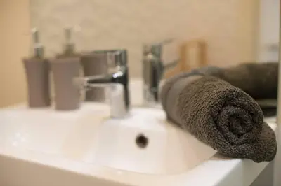 a roll of brown towel sitting on a bathroom sink at STUDIO ORANGERS in Nice