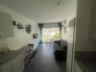 a living room with a couch and a table at STUDIO ORANGERS in Nice
