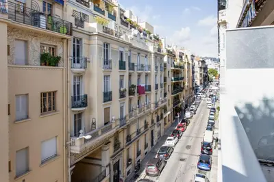 a view of a city street with cars parked at Le Refuge Acajou - Welkeys in Nice