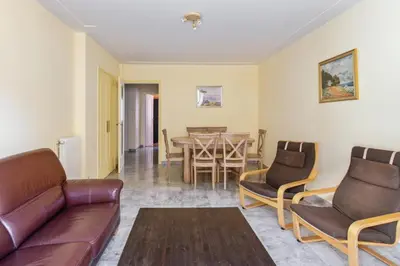 a living room with a couch and a table and chairs at Le Refuge Acajou - Welkeys in Nice