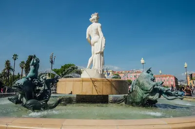 a statue of a woman standing in a fountain at 