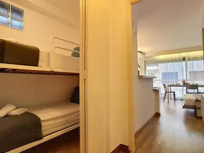 a small room with bunk beds and a dining room at Nestor&Jeeves - LIDO BEACH - Central - Very close sea - Pedestrian zone in Nice