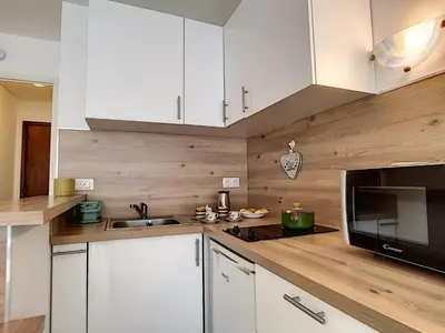 a kitchen with white cabinets and a sink and a microwave at Nestor&Jeeves - LIDO BEACH - Central - Very close sea - Pedestrian zone in Nice