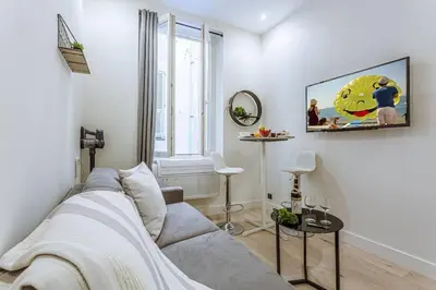 a living room with a couch and a window at MY CASA - BUNICO 1 - Old Town Renovated Studio in Nice
