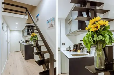 a kitchen with a staircase and a vase of flowers at MY CASA - BUNICO 1 - Old Town Renovated Studio in Nice