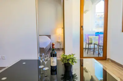 a bottle of wine and two glasses on a counter at MASSENET PIETONNE AP4196 by Riviera Holiday Homes in Nice