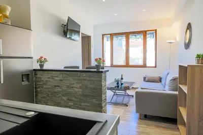 a living room with a couch and a table at MASSENET PIETONNE AP4196 by Riviera Holiday Homes in Nice