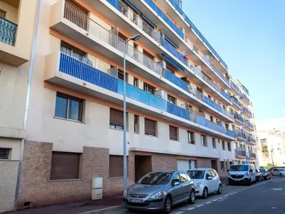 an apartment building with cars parked in front of it at Apartment L'Amiral-1 by Interhome in Cagnes-sur-Mer