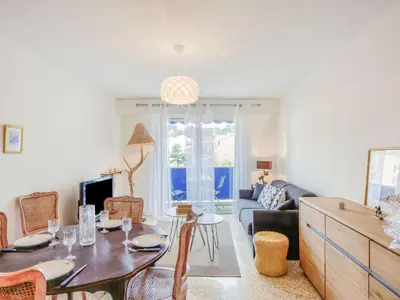 a living room with a table and a couch at Apartment L'Amiral-1 by Interhome in Cagnes-sur-Mer