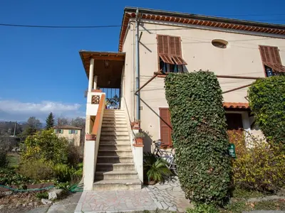 a house with a stairway leading up to a door at Apartment Le Narcisse by Interhome in Cagnes-sur-Mer