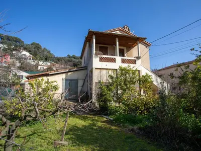 a house on a hill with trees in the foreground at Apartment Le Narcisse by Interhome in Cagnes-sur-Mer
